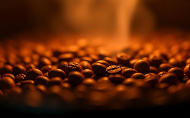 Kávészemek pörkölés közben, lángok és füsttel